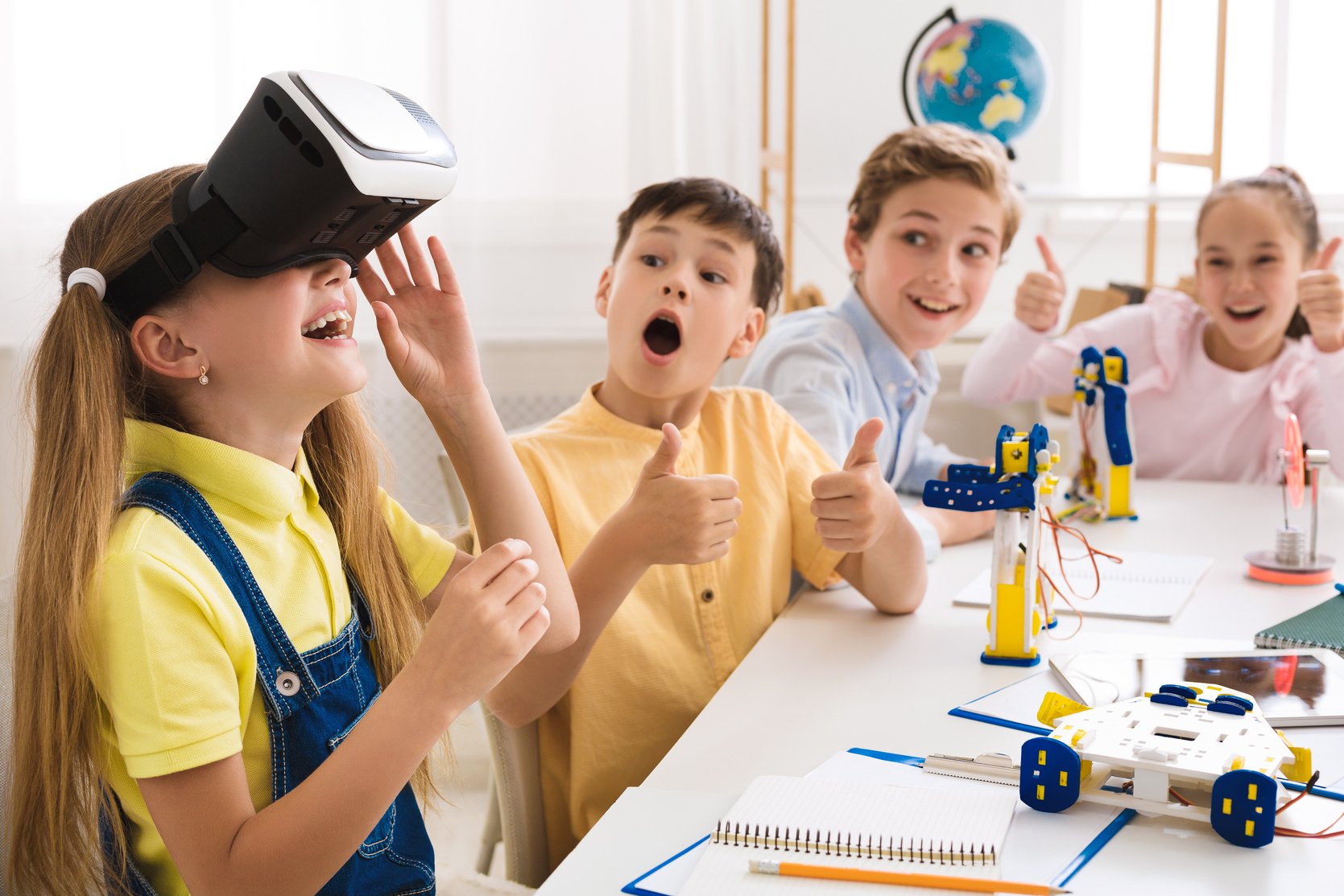 School children playing with vr glasses in school